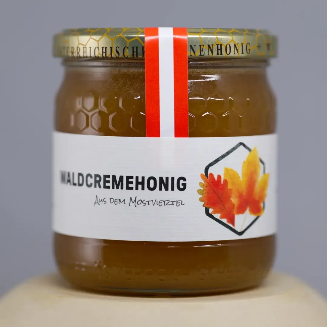 Jar of creamy Forest Honey with a spreadable consistency
