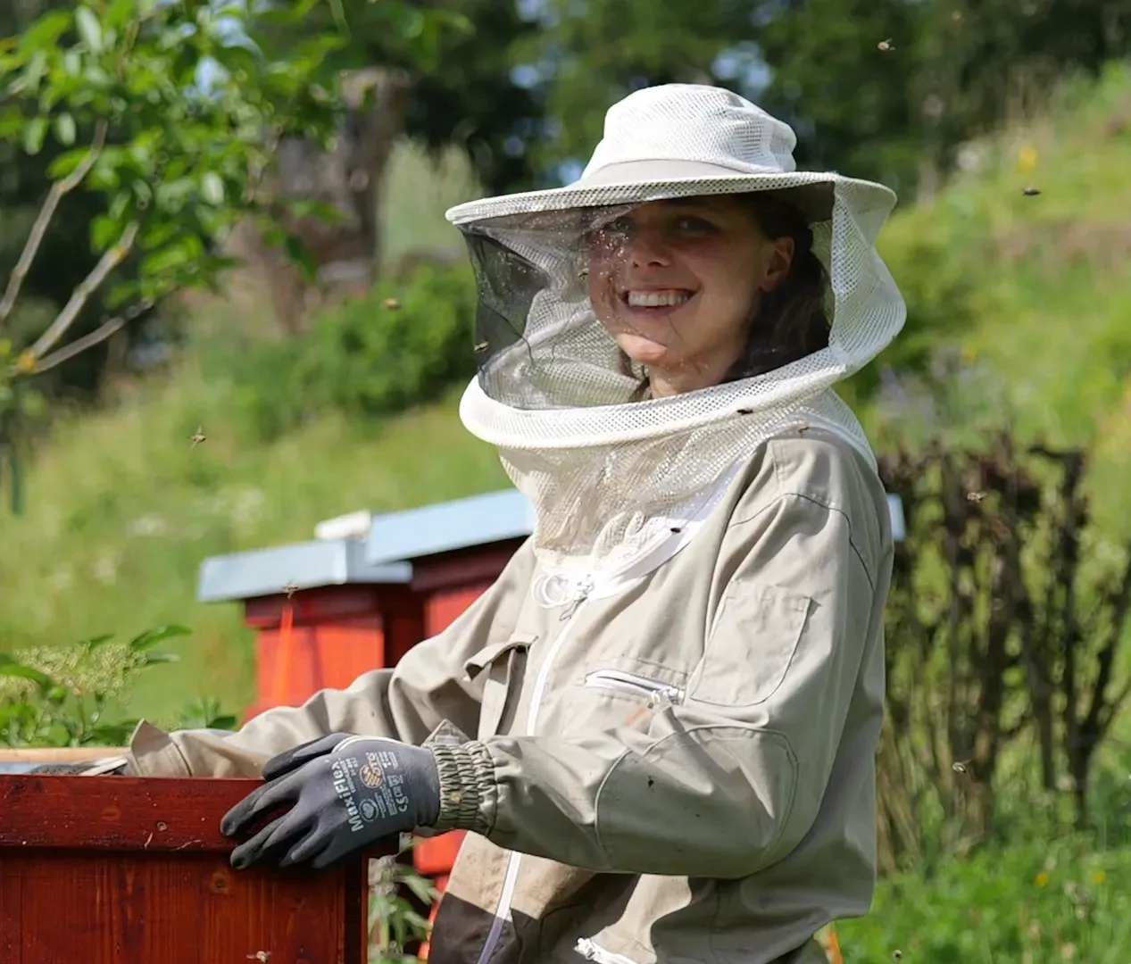 Portrait of Romi working with the bees